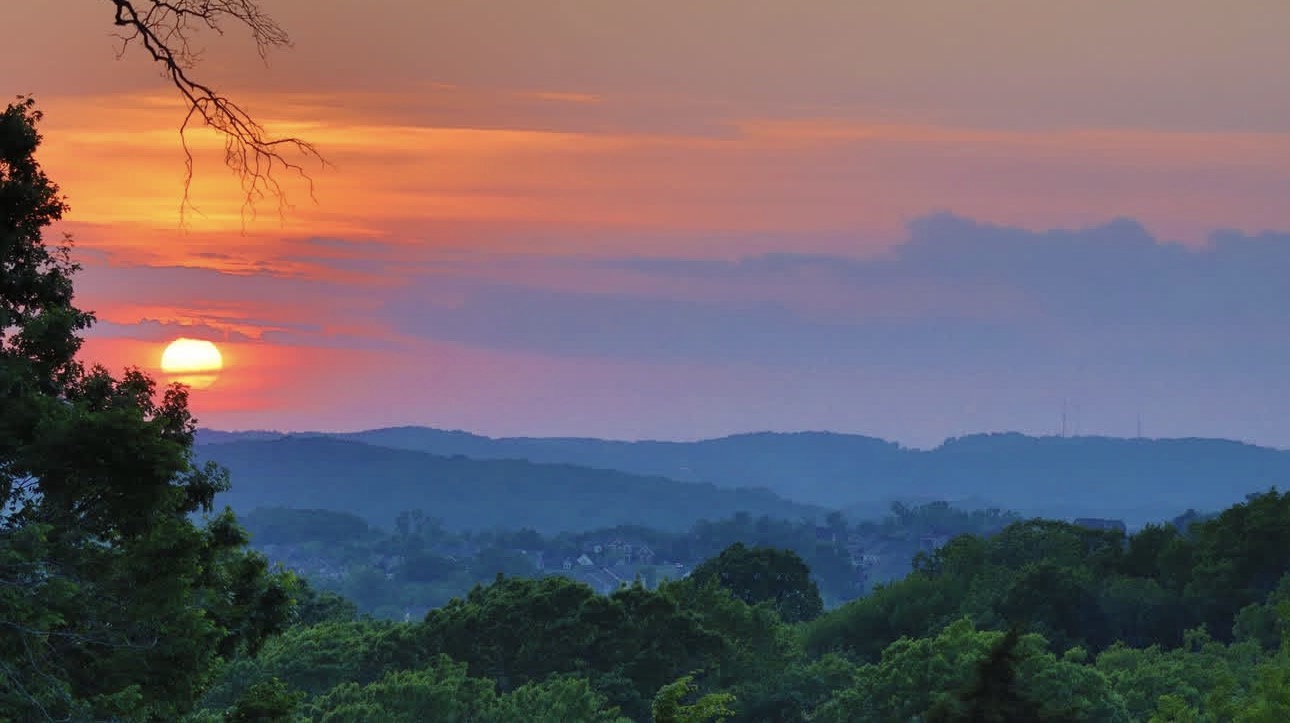 A vivid red and blue sunset over the Tennessee hills
